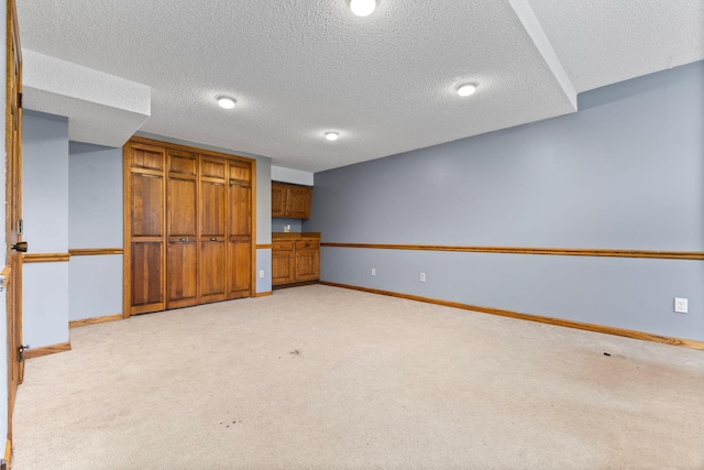 1900 Vernon Dr S, Minnetonka, MN 55305 - finished below grade area featuring baseboards, light colored carpet, and a textured ceiling