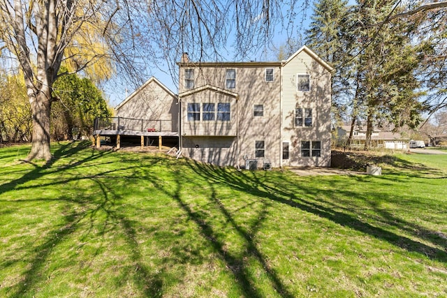 1900 Vernon Dr S, Minnetonka, MN 55305 - back of property with a deck, a yard, and a chimney