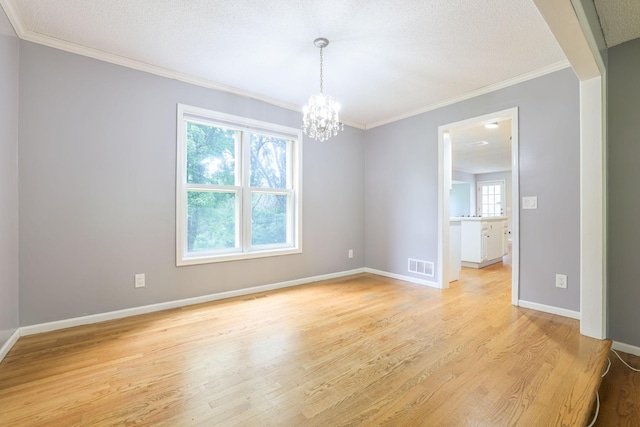 1900 Vernon Dr S, Minnetonka, MN 55305 - unfurnished room featuring light wood-style flooring, a chandelier, baseboards, ornamental molding, and a textured ceiling