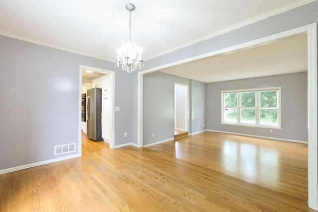 1900 Vernon Dr S, Minnetonka, MN 55305 - spare room with a chandelier, light wood-style floors, baseboards, and crown molding
