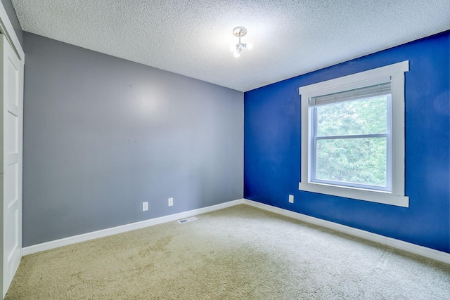 1900 Vernon Dr S, Minnetonka, MN 55305 - spare room with carpet flooring, a textured ceiling, and baseboards