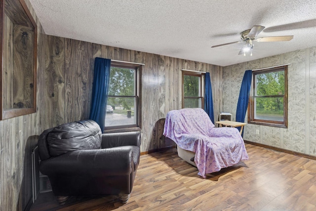 100 2nd St S, Delano, MN 55328 - sitting room with plenty of natural light, baseboards, a textured ceiling, wood finished floors, and ceiling fan