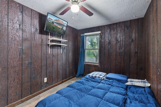 100 2nd St S, Delano, MN 55328 - bedroom featuring a textured ceiling, wooden walls, and a ceiling fan