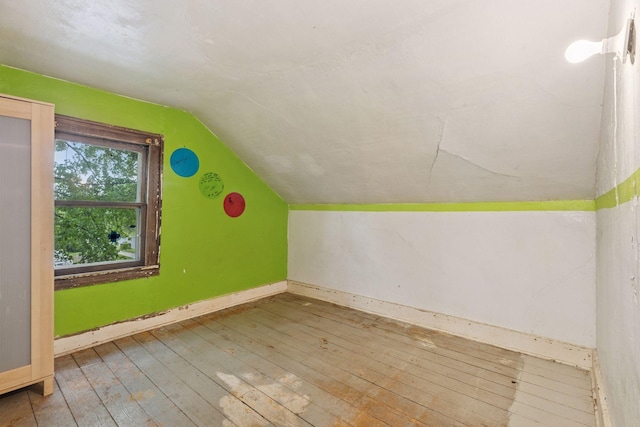 100 2nd St S, Delano, MN 55328 - additional living space with lofted ceiling, hardwood / wood-style flooring, and baseboards