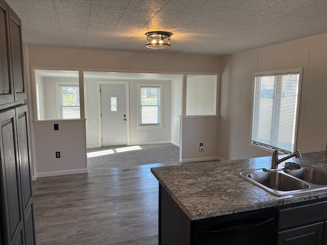 706 3rd Ave N, Lakefield, MN 56150 - kitchen with baseboards, a wealth of natural light, a sink, and dark wood-type flooring
