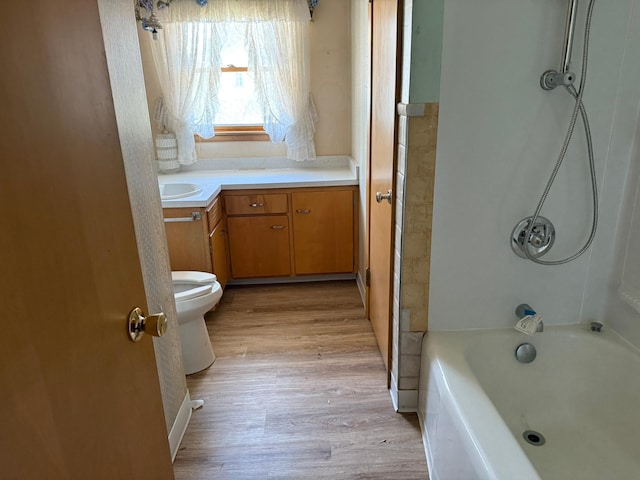 314 Burr Oak Dr, Albert Lea, MN 56007 - bathroom featuring wood finished floors, toilet,  shower combination, and vanity