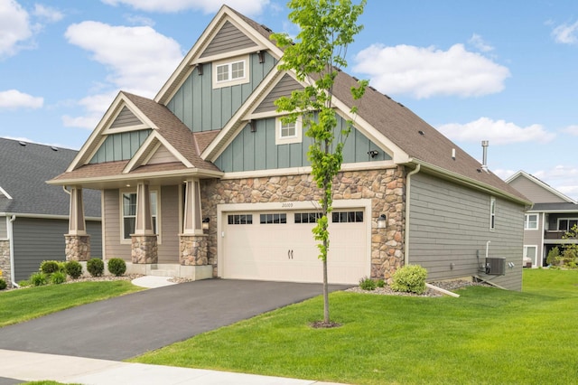 20109 Geneva Trl, Lakeville, MN 55044 - craftsman-style home featuring board and batten siding, stone siding, a front lawn, and asphalt driveway
