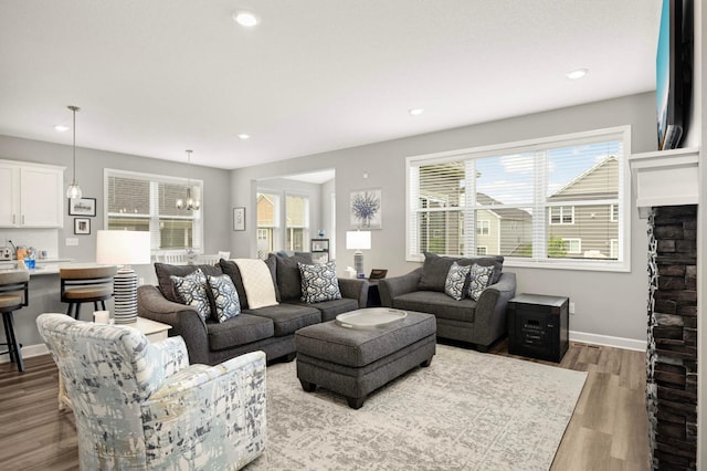 20109 Geneva Trl, Lakeville, MN 55044 - living area with wood finished floors, recessed lighting, baseboards, and a chandelier