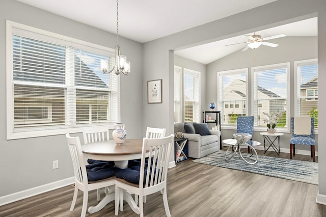 20109 Geneva Trl, Lakeville, MN 55044 - dining space with baseboards, wood finished floors, vaulted ceiling, a chandelier, and a ceiling fan