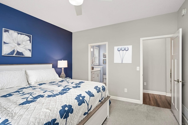 20109 Geneva Trl, Lakeville, MN 55044 - carpeted bedroom with baseboards, connected bathroom, and a ceiling fan