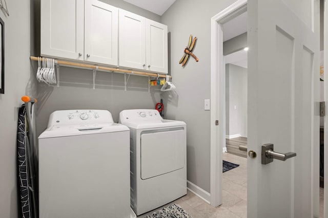 20109 Geneva Trl, Lakeville, MN 55044 - washroom featuring cabinet space, washing machine and clothes dryer, baseboards, and light tile patterned flooring