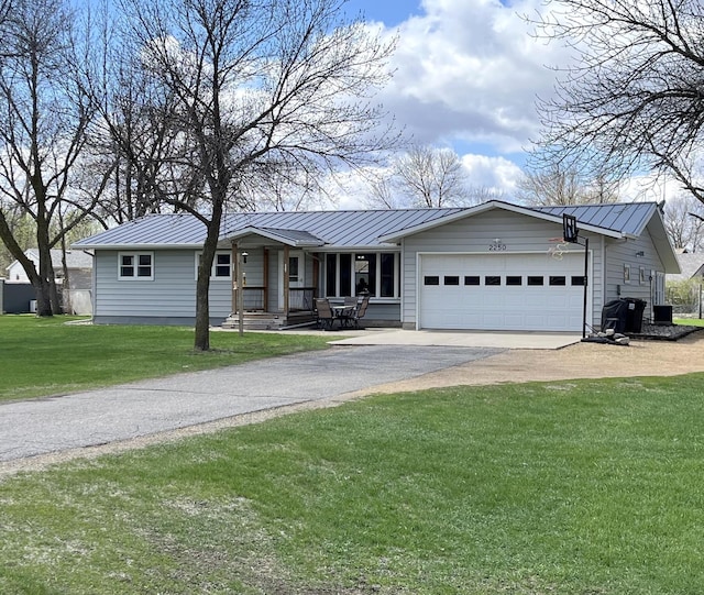 2250 18th Ave, Windom, MN 56101 - ranch-style house featuring driveway, an attached garage, a metal roof, and a standing seam roof