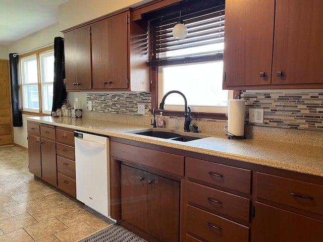 2250 18th Ave, Windom, MN 56101 - kitchen featuring dishwasher, light countertops, backsplash, and stone finish floors