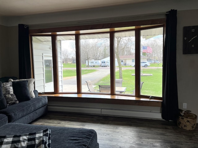 2250 18th Ave, Windom, MN 56101 - living area with a baseboard heating unit, wood finished floors, and healthy amount of natural light