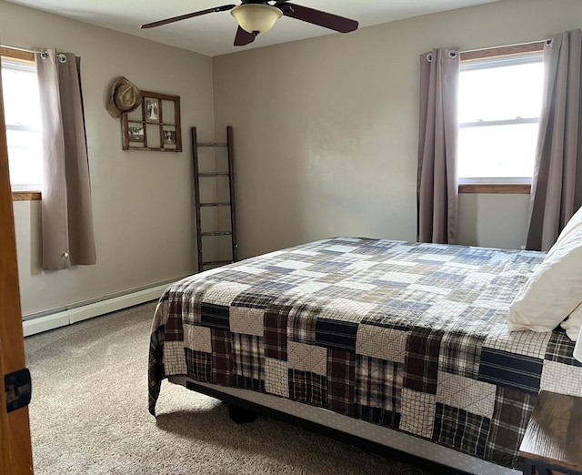 2250 18th Ave, Windom, MN 56101 - bedroom featuring a baseboard heating unit, carpet floors, and a ceiling fan