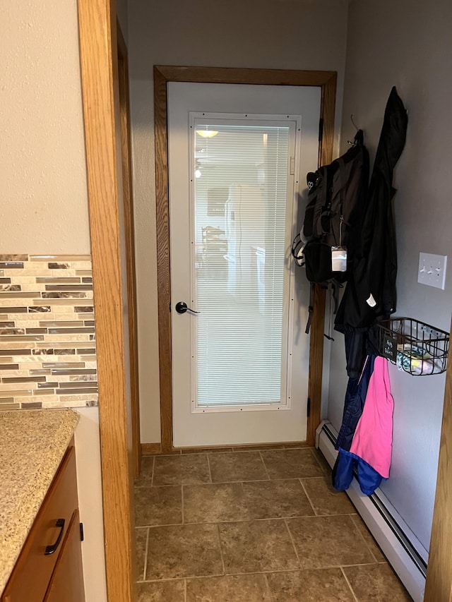 2250 18th Ave, Windom, MN 56101 - entryway featuring a baseboard radiator and dark stone finish flooring