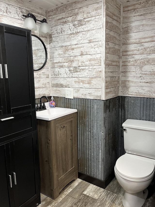 2250 18th Ave, Windom, MN 56101 - half bathroom with wood walls, vanity, and wood finished floors