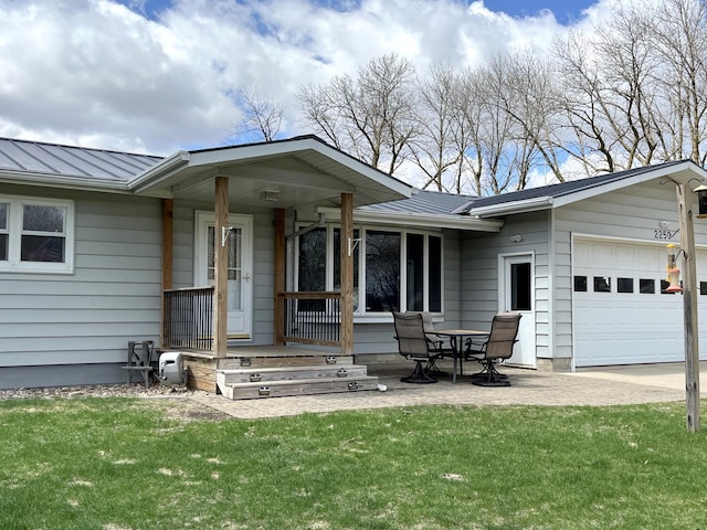 2250 18th Ave, Windom, MN 56101 - view of front of house with a standing seam roof, a garage, a metal roof, and a front lawn