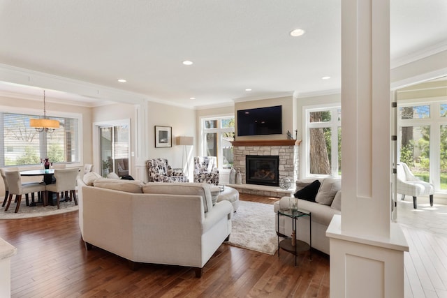204 8th Ave S, Princeton, MN 55371 - living area with crown molding, a stone fireplace, dark wood-type flooring, a chandelier, and recessed lighting