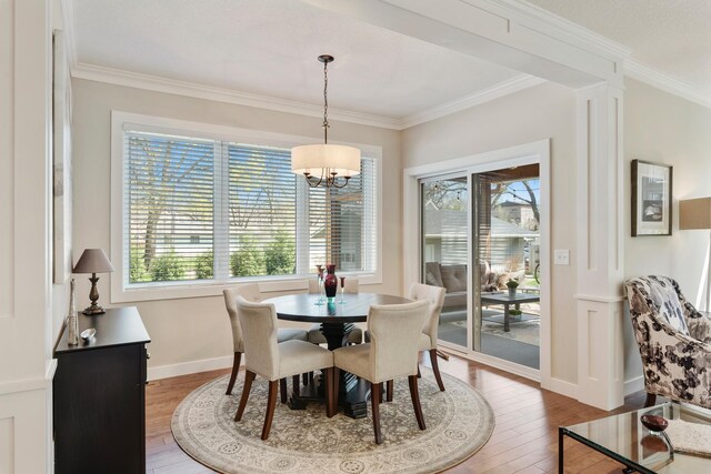 204 8th Ave S, Princeton, MN 55371 - dining room featuring hardwood / wood-style floors, crown molding, and a chandelier