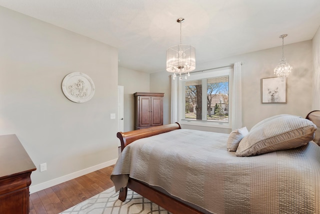 204 8th Ave S, Princeton, MN 55371 - bedroom featuring a chandelier and wood finished floors