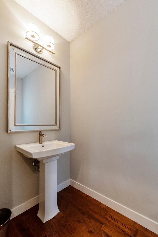 204 8th Ave S, Princeton, MN 55371 - bathroom with wood finished floors and a textured ceiling