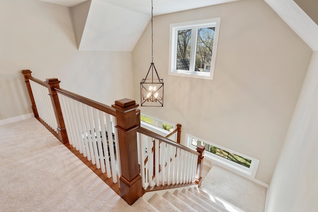 204 8th Ave S, Princeton, MN 55371 - staircase featuring a chandelier, lofted ceiling, and carpet flooring