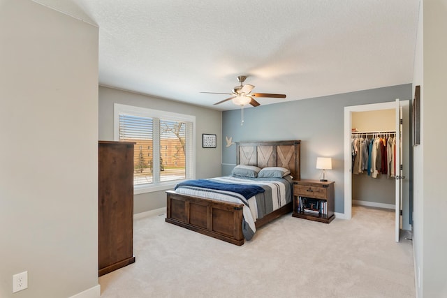 204 8th Ave S, Princeton, MN 55371 - bedroom featuring a walk in closet, carpet flooring, a ceiling fan, and a closet