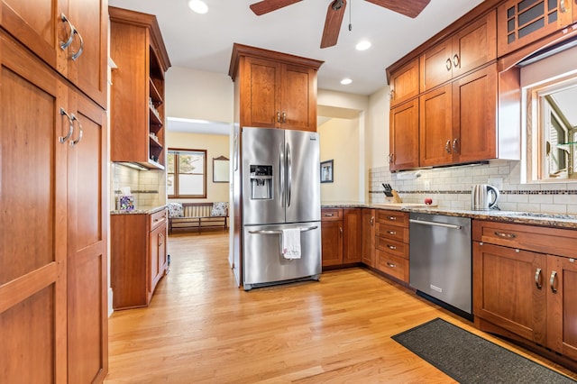 kitchen with brown cabinets, stainless steel appliances, light wood-style flooring, and open shelves