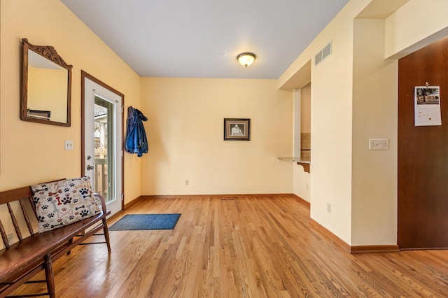 entrance foyer featuring baseboards, light wood-type flooring, and visible vents