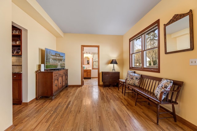 sitting room featuring light wood-style flooring and baseboards