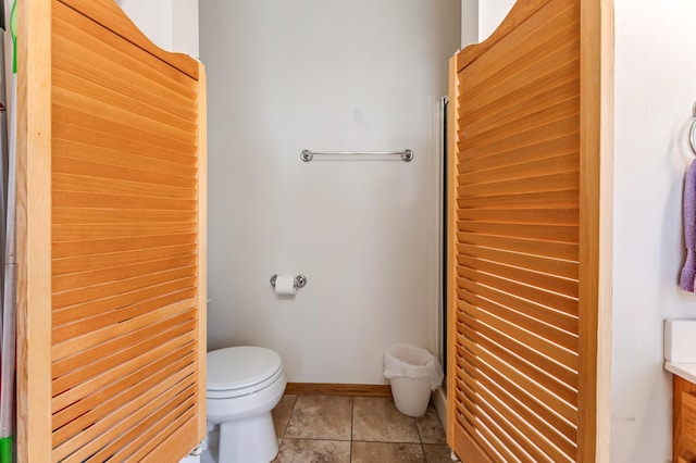 full bathroom with curtained shower, tile patterned flooring, toilet, and baseboards