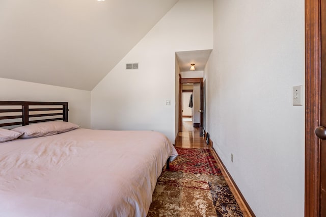 bedroom with lofted ceiling and visible vents