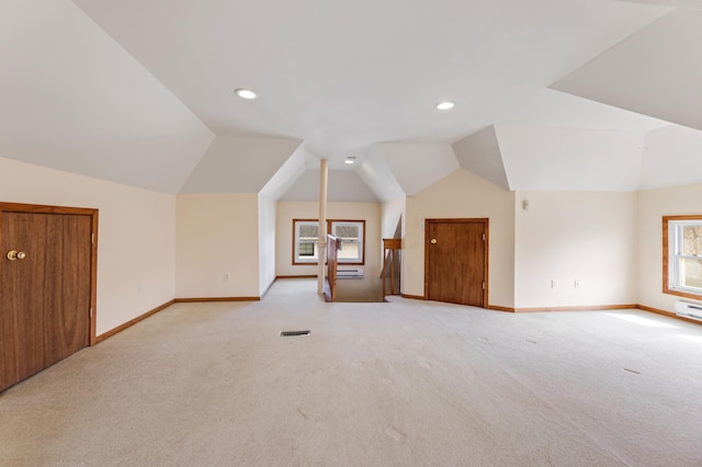 additional living space with light colored carpet, lofted ceiling, baseboards, and recessed lighting