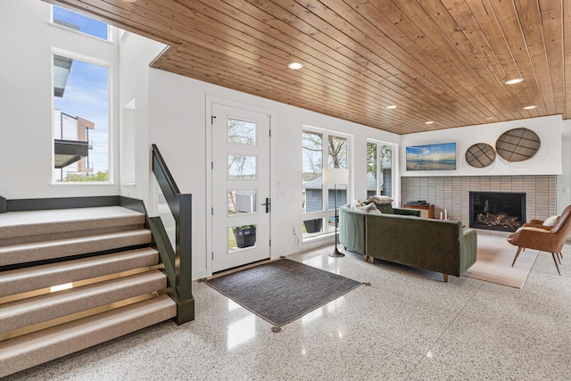 4919 Three Points Blvd, Mound, MN 55364 - entryway featuring a tile fireplace, speckled floor, wooden ceiling, and recessed lighting