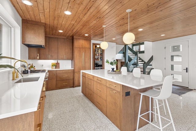 4919 Three Points Blvd, Mound, MN 55364 - kitchen featuring a sink, brown cabinetry, a large island, wooden ceiling, and recessed lighting