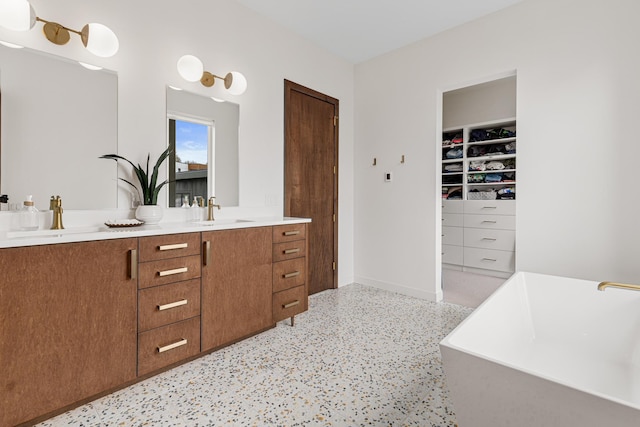 4919 Three Points Blvd, Mound, MN 55364 - full bath with double vanity, a freestanding tub, a spacious closet, and a sink
