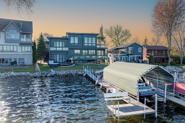 4919 Three Points Blvd, Mound, MN 55364 - dock area featuring boat lift, a water view, and a lawn