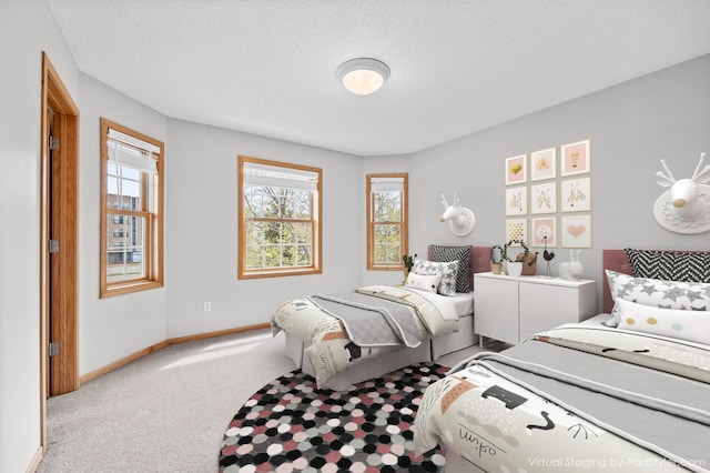 bedroom with multiple windows, baseboards, and carpet floors