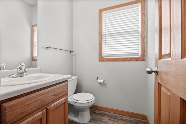 3014 39th St, Minneapolis, MN 55406 - bathroom featuring vanity, wood finished floors, toilet, and baseboards