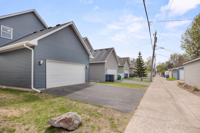 3014 39th St, Minneapolis, MN 55406 - view of home's exterior with driveway, an attached garage, a residential view, and a shingled roof