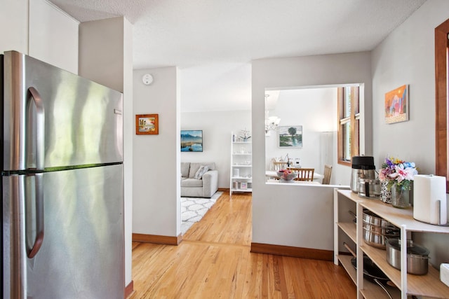 3664 Abbey Way Unit C, Eagan, MN 55123 - kitchen featuring freestanding refrigerator, wood finished floors, baseboards, and a chandelier