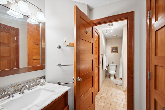 3664 Abbey Way Unit C, Eagan, MN 55123 - bathroom featuring toilet, vanity, tile patterned floors, and decorative backsplash