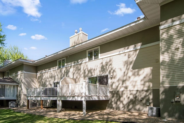 3664 Abbey Way Unit C, Eagan, MN 55123 - rear view of house featuring a chimney, a deck, cooling unit, and stucco siding