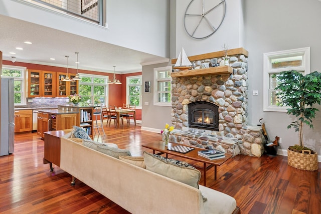 16710 Edgewood Ave, Wayzata, MN 55391 - living area with wood finished floors, a towering ceiling, ornamental molding, a fireplace, and healthy amount of natural light