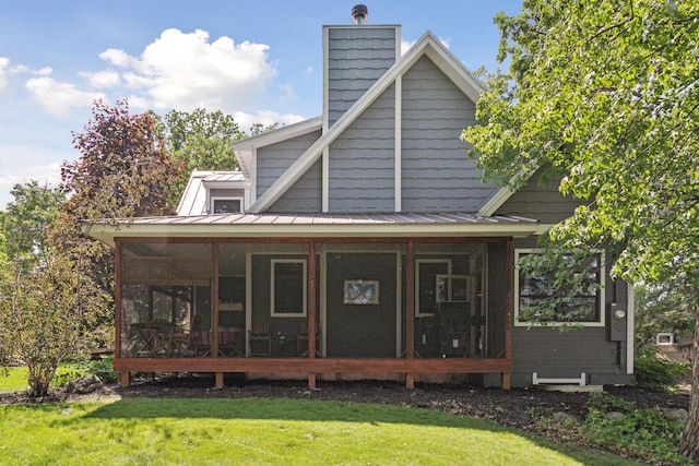 16710 Edgewood Ave, Wayzata, MN 55391 - rear view of property featuring a yard, a sunroom, a chimney, and a standing seam roof
