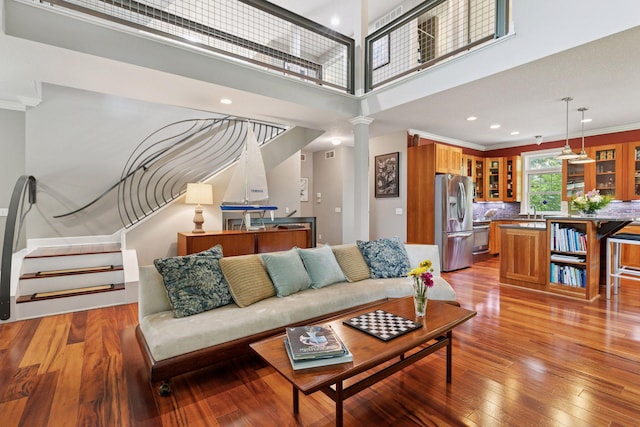 16710 Edgewood Ave, Wayzata, MN 55391 - living area featuring stairway, light wood-type flooring, decorative columns, crown molding, and recessed lighting