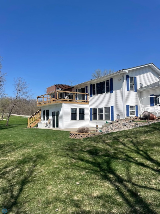 rear view of property featuring stairway and a yard