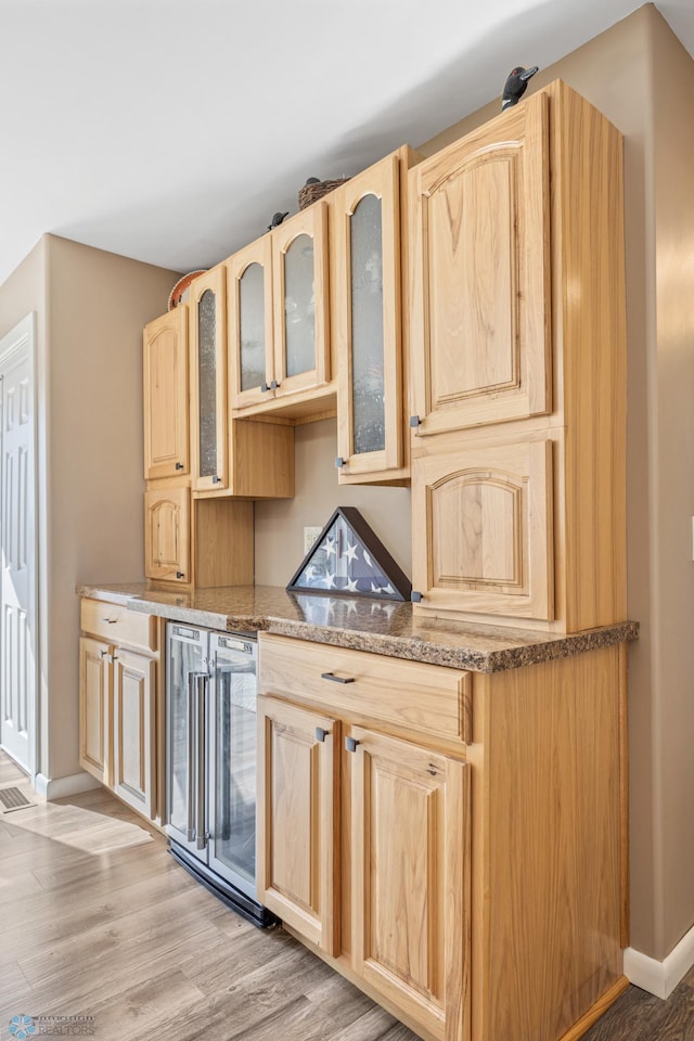 15344 Blackhawk Rd, Lake Eunice Twp, MN 56511 - kitchen featuring light brown cabinetry, beverage cooler, and baseboards