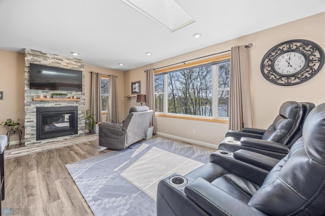 15344 Blackhawk Rd, Lake Eunice Twp, MN 56511 - living area featuring wood finished floors, baseboards, a fireplace, and recessed lighting
